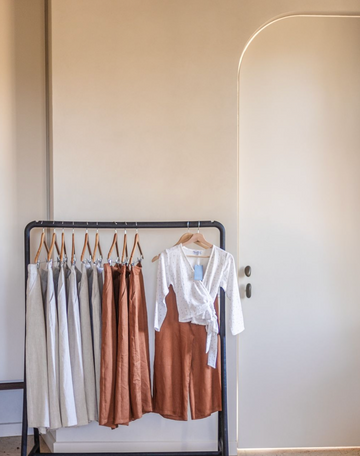 clothes hanging on a clothing rack 