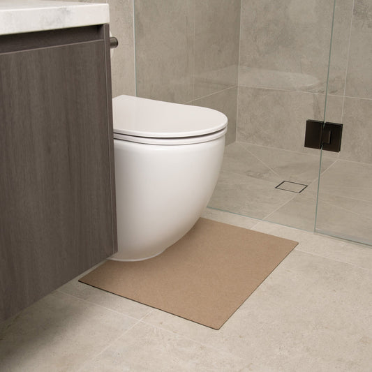 Beige toilet floor mat in a bathroom