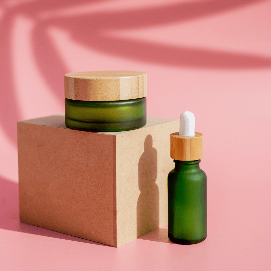 Frosted Green  Cosmetic Jar and Dropper bottle in a pink background