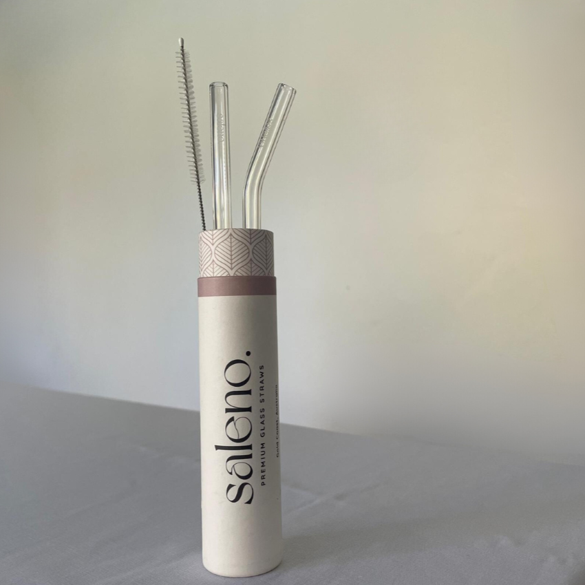 two glass straws and a brush in a saleno tube