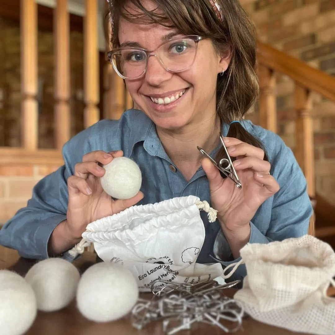 a person holding the the wool and peg. Eco Friendly Laundry Bundle | us and the earth